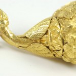 A close up of the gold leaf on the end of a bird