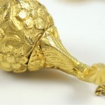 A close up of the top part of a gold object