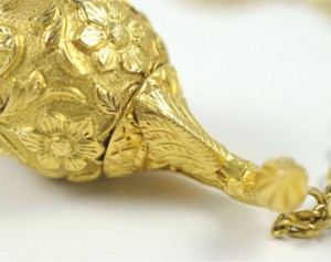 A close up of the top part of a gold object