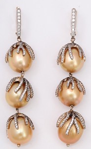 A pair of gold and diamond earrings with pearls.