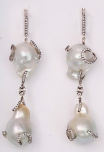 A pair of earrings with pearls and diamonds.