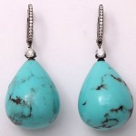 A pair of turquoise and diamond earrings.