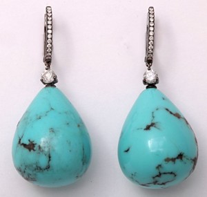 A pair of turquoise and diamond earrings.