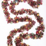 A long necklace of multicolored beads is shown.