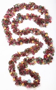 A long necklace of multicolored beads is shown.