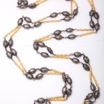 A long necklace with yellow and black beads