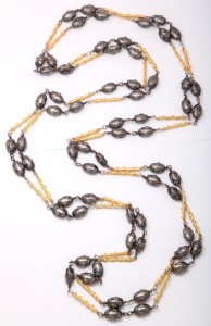 A long necklace with yellow and black beads