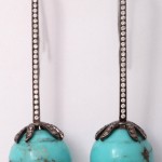 A pair of turquoise and diamond earrings.