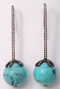 A pair of turquoise and diamond earrings.