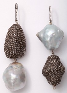 A pair of earrings with pearls and beads.