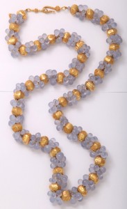 A long necklace of gold and blue beads.