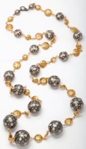 A long necklace with gold and black beads