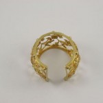 A gold ring with a floral design on it.