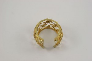 A gold ring with a floral design on it.