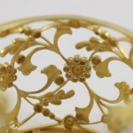 A close up of the gold filigree on the bottom of a bowl