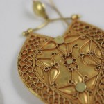 A close up of the gold filigree on a necklace