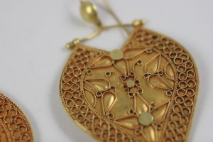 A close up of the gold filigree on a necklace