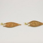 A pair of gold earrings with a diamond shaped design.