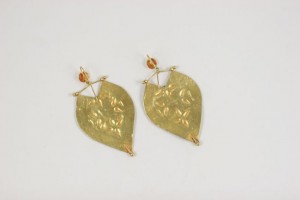 A pair of gold leaf earrings with a yellow stone.