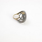 A ring with a black stone on it's side.