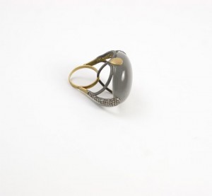 A ring with a black stone on it's side.