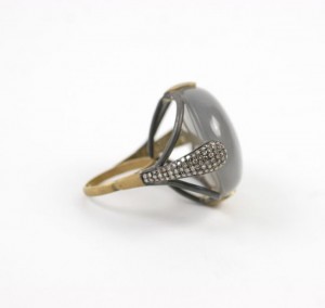 A ring with a large gray stone and diamond accents.