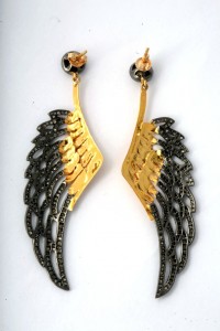 A pair of earrings with gold and black wings.
