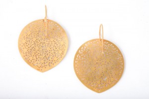 A pair of gold earrings with a leaf design.