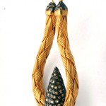 A yellow and black necklace with two strands of gold.