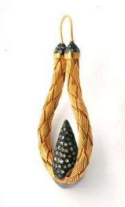 A yellow and black necklace with two strands of gold.