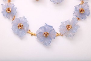A close up of a necklace with flowers