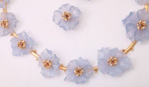 A necklace and earrings set of blue flowers.