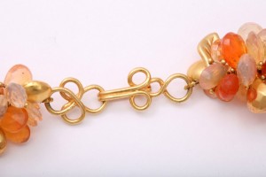 A close up of the gold chain on a necklace
