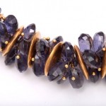 A close up of the necklace with purple stones