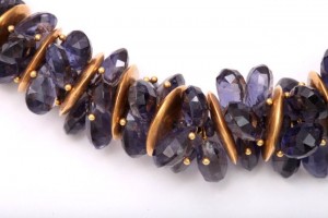 A close up of the necklace with purple stones