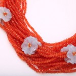 A close up of a necklace with orange beads