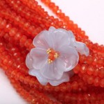 A close up of a flower on some beads