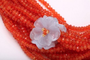 A close up of a flower on some beads
