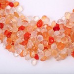 A close up of some orange and white beads