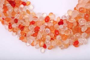 A close up of some orange and white beads