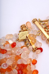 A close up of some beads and a gold chain