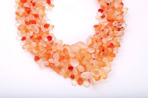 A close up of a necklace with many different colored beads