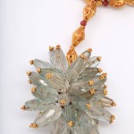 A close up of the necklace with a large flower