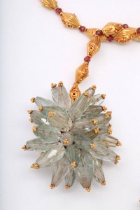 A close up of the necklace with a large flower