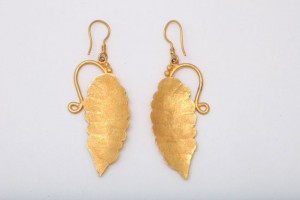 A pair of gold earrings with leaves on them.