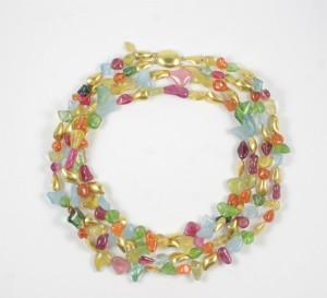 A necklace of colorful beads and gold leaves.