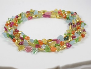 A necklace of colorful beads is shown on the table.