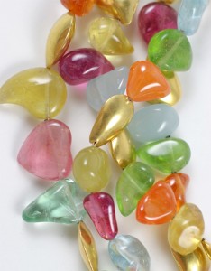 A bunch of different colored beads on the table