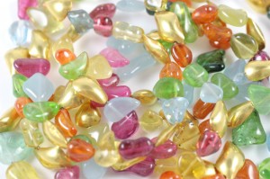 A close up of many different colored beads