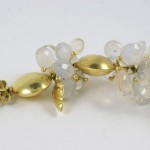 A pair of gold earrings with white stones.